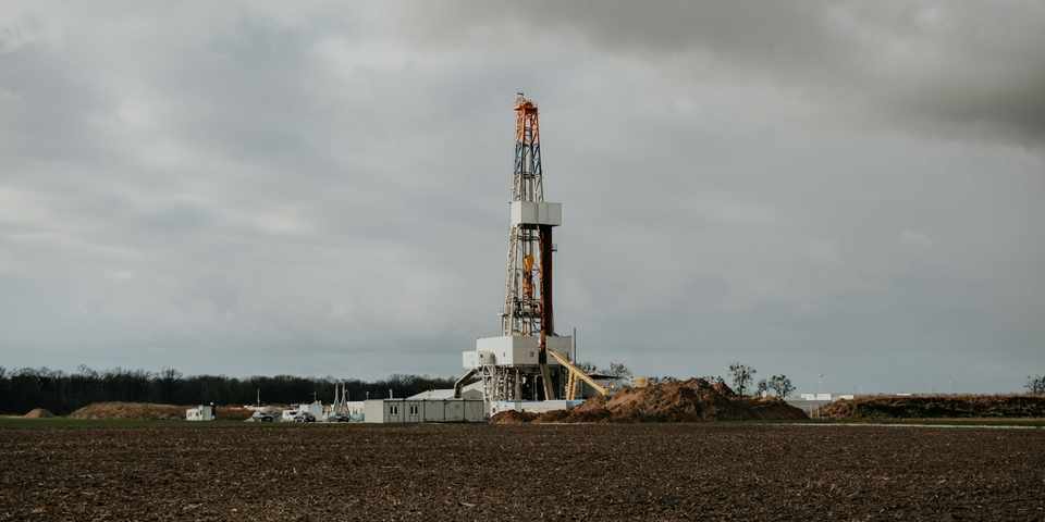 Water well drilling rig set up in an open field