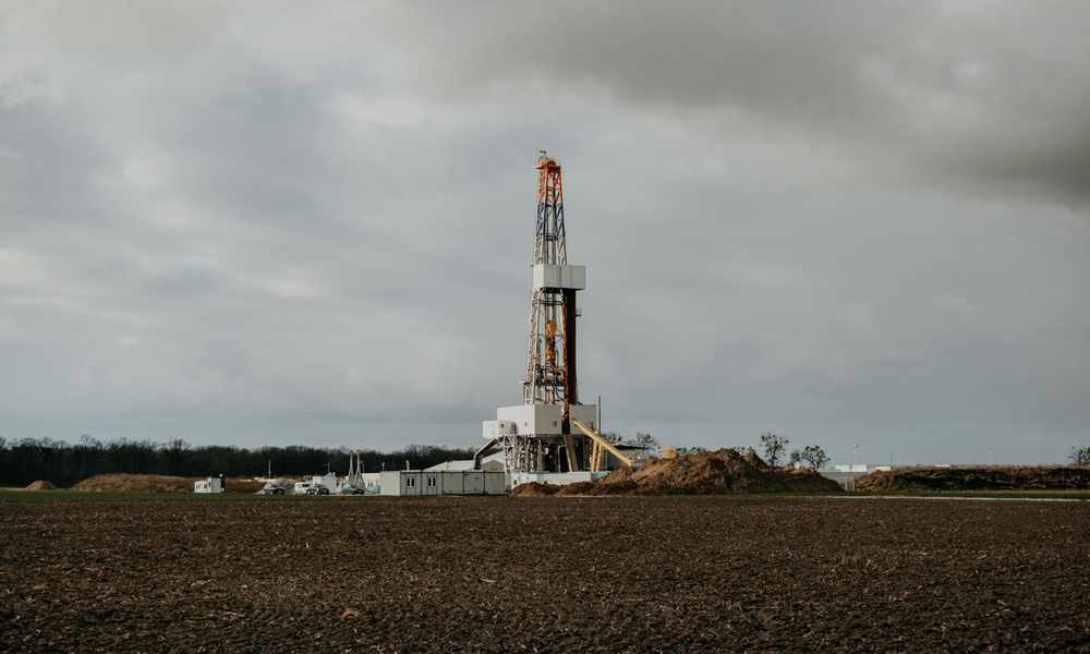 Water well drilling rig at work in an open West Texas field