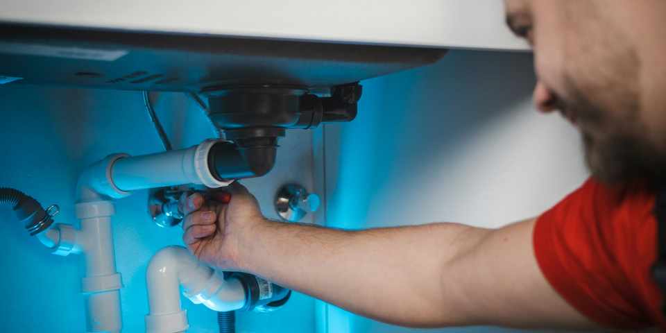 Well technician working on water line pipework