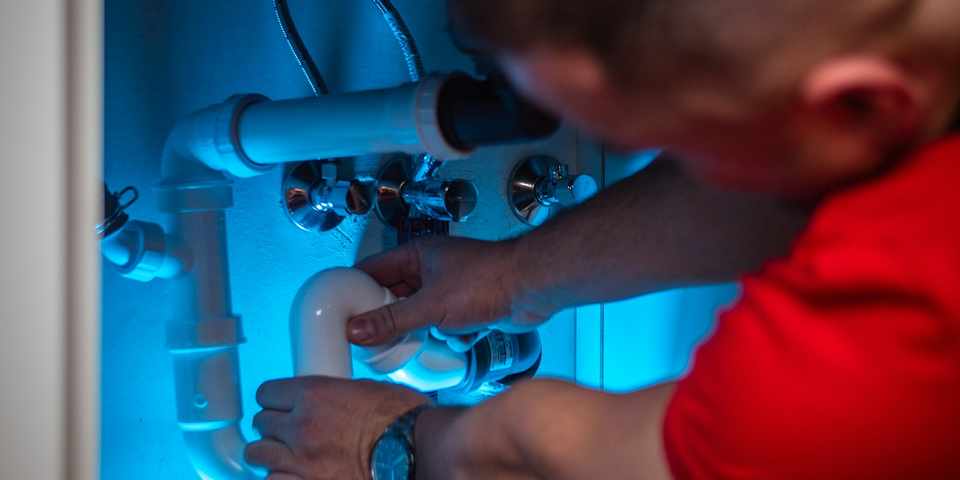 Well pump and pipework being serviced by a technician